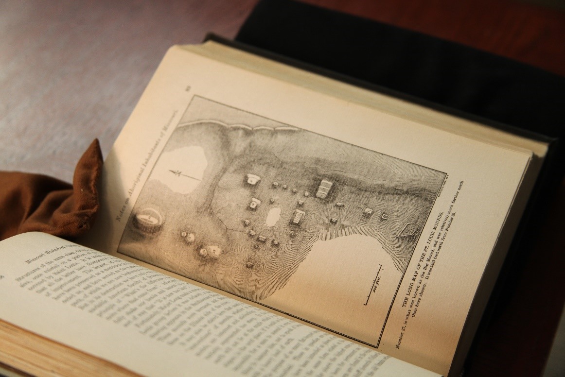 image shows an old book opened on page displaying a hand-drawn map