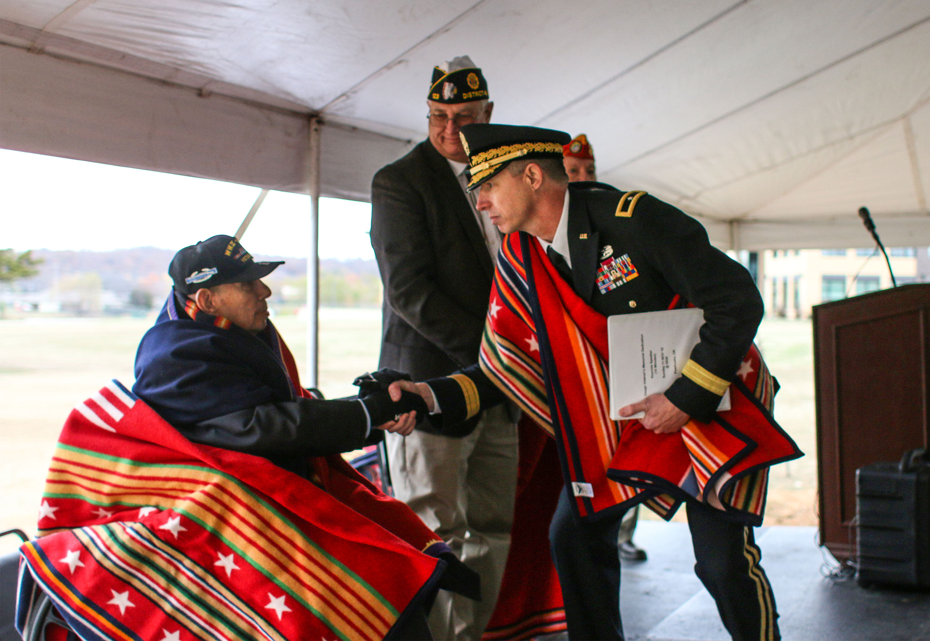 A Veteran’s Respect, November 11, 2018.  The late Capt. Richard Luttrell, 45th Infantry Division veteran, shakes the hand of Gen. Louis Wilhelm, Keynote for dedication. Photo: Shannon Shaw Duty.  Image courtesy of Osage News. A Veteran’s Respect, November 11, 2018.  The late Capt. Richard Luttrell, 45th Infantry Division veteran, shakes the hand of Gen. Louis Wilhelm, Keynote for dedication. Photo: Shannon Shaw Duty.  Image courtesy of Osage News.