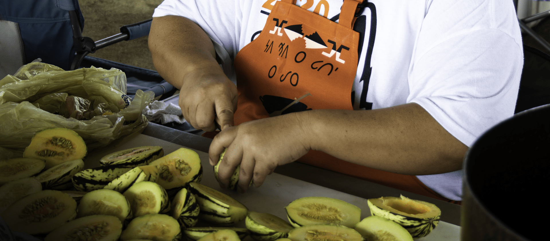 Wahzhazhe cook prepares squash, a traditional food, that was donated by Harvestland during Grayhorse Inlonshka (2021). 