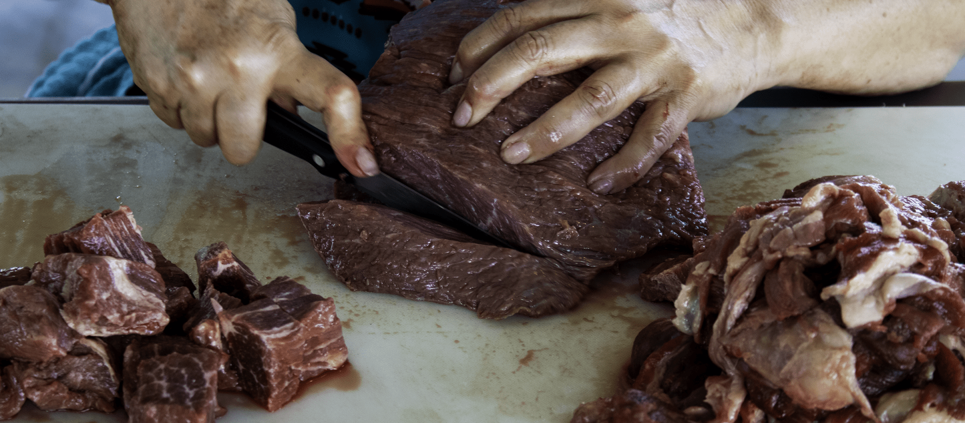A cook preparing meat for meat gravy. 