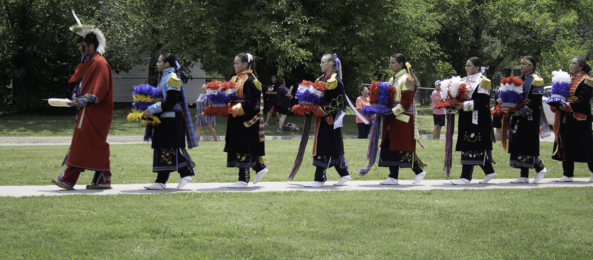 Pawhuska Drumkeeper walks towards the arbor during the ceremony to pay for the drum (2021). 