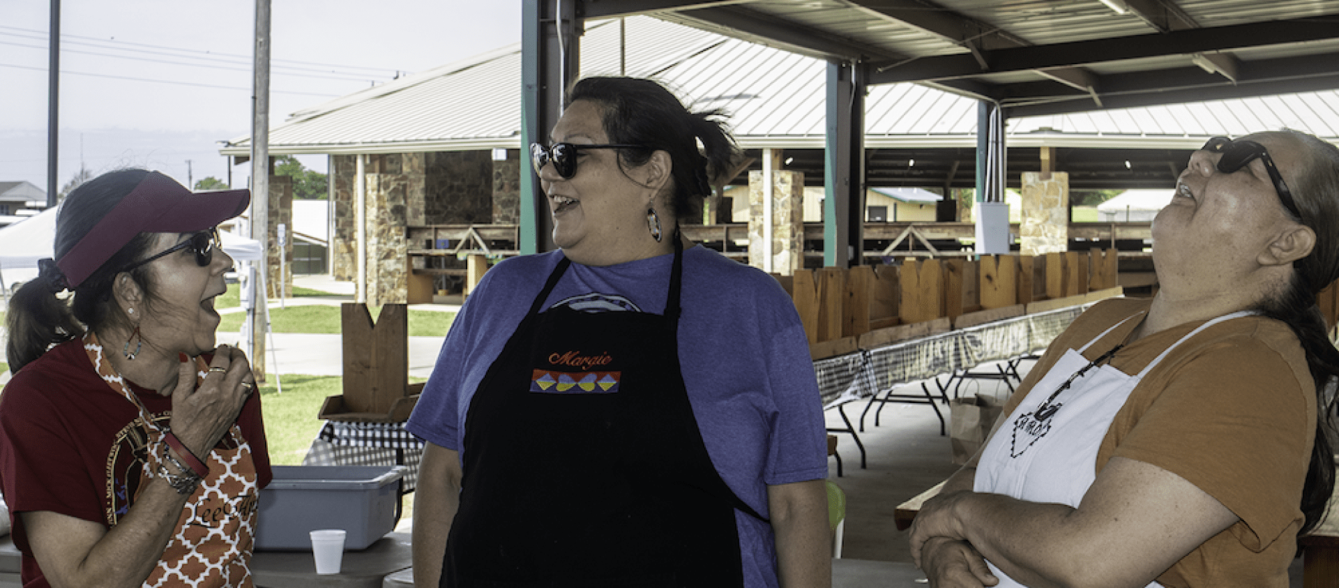 Pawhuska cooks preparing food (and having a laugh) at Grayhorse Inlonshka 2022. 