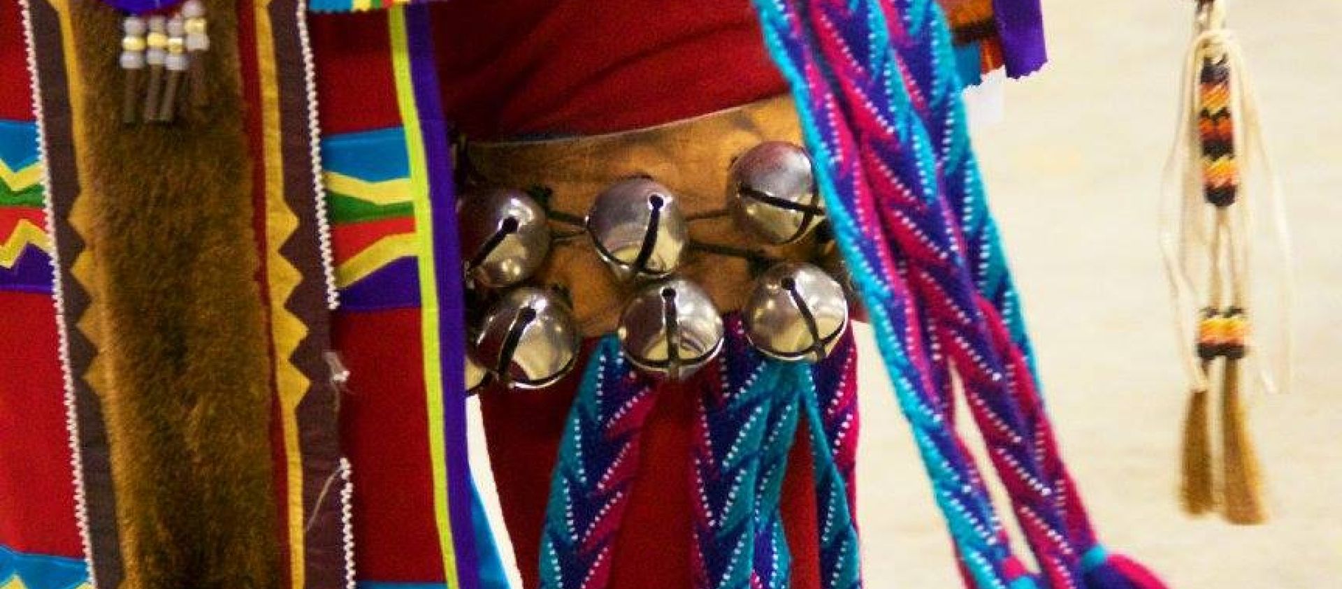 Wahzhazhe man with otter hide, finger woven streamers and fully beaded moccasins.