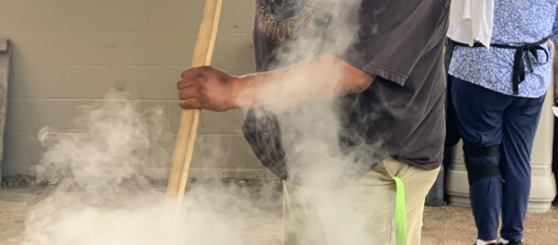 Hominy cook stirs meat to prepare for meat gravy. 