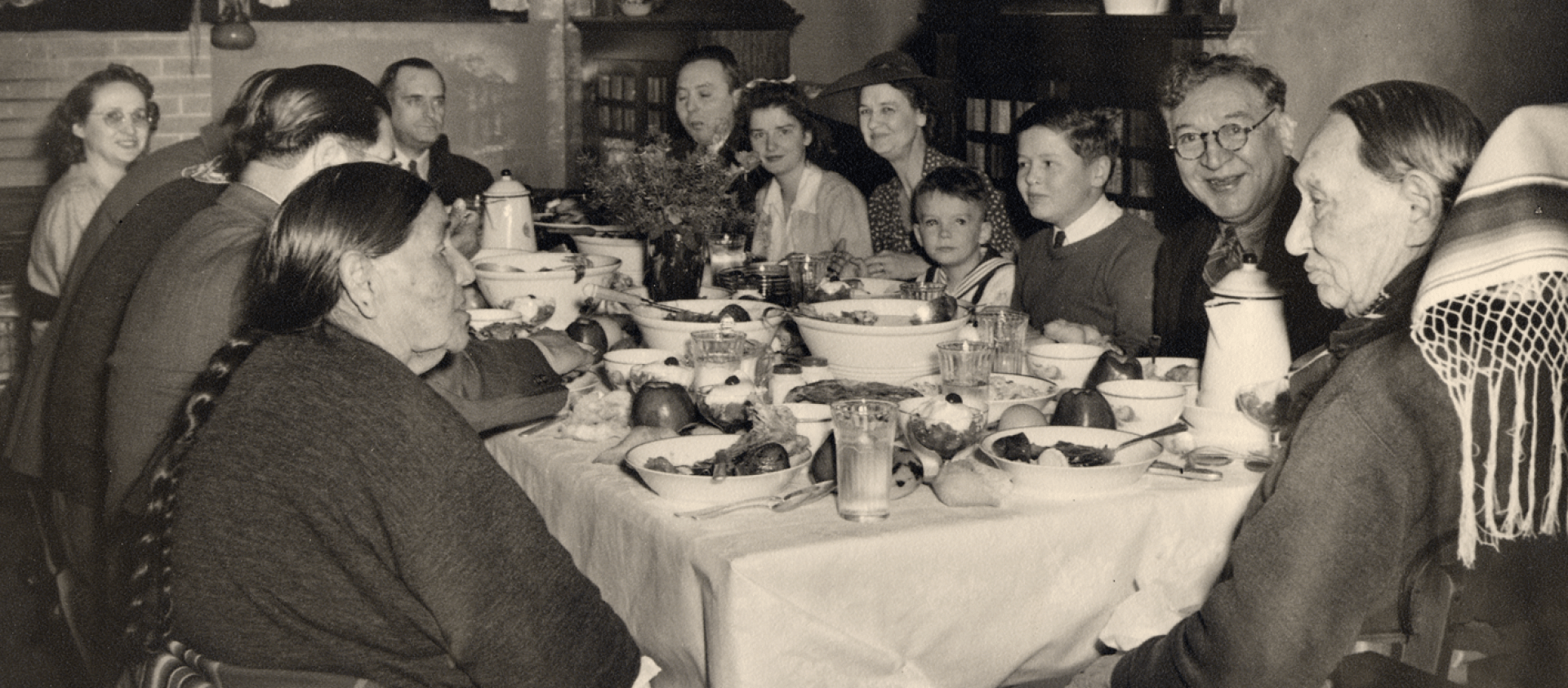 Photo Caption: Chief Fred Lookout at the head of the dinner table with his wife Julia Lookout to his left, n.d. ONM Collection P01-1261.